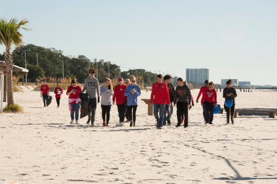 Left: A school group collects trash and data during the Mississippi Coastal Cleanup event. Photo by Agricultural Communications.