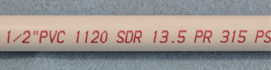 PVC pipe with "1/2"PVC 1120 SDR 13.5 PR 315 PS" written on the side.