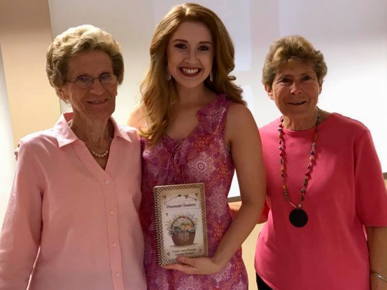 Two women who attended the Breast Cancer Awareness Luncheon pictured with speaker Molly May.  