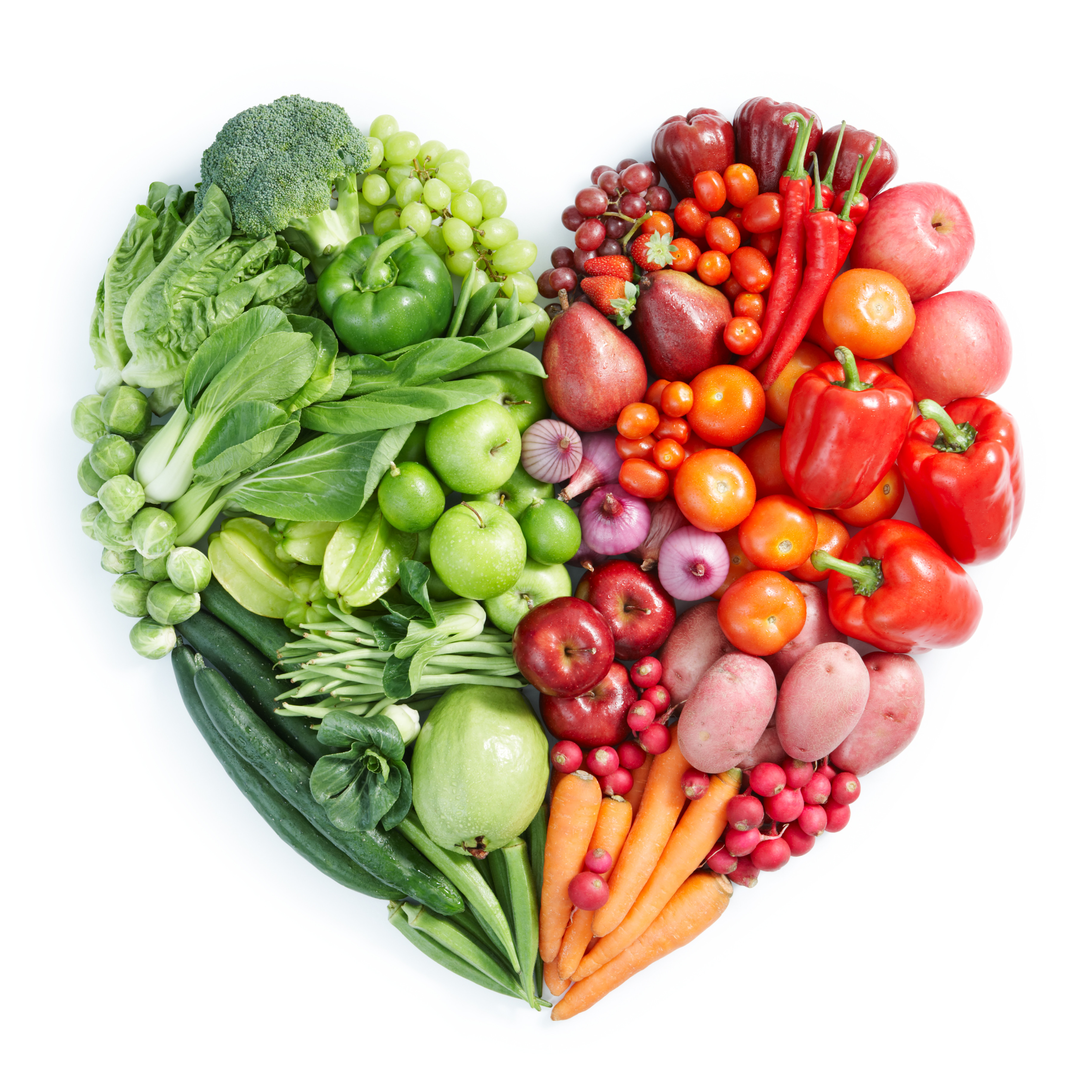 An assortment of green, orange, and red vegetables are arranged in a heart shape. 