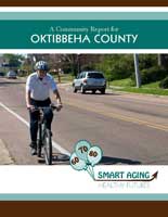 Advertisement for Oktibbeha county with a man riding a bike on the side of the road.