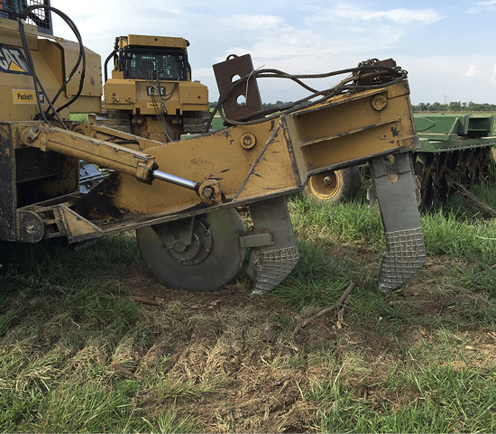 A double shank subsoiler is shown preparing a former pasture for planting.