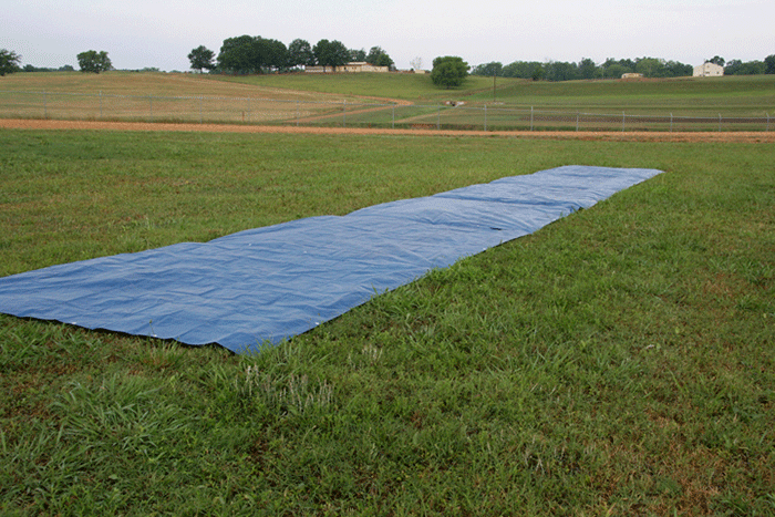 This is an image of a tarp placed on a field to use in calibrating poultry litter spreading equipment.