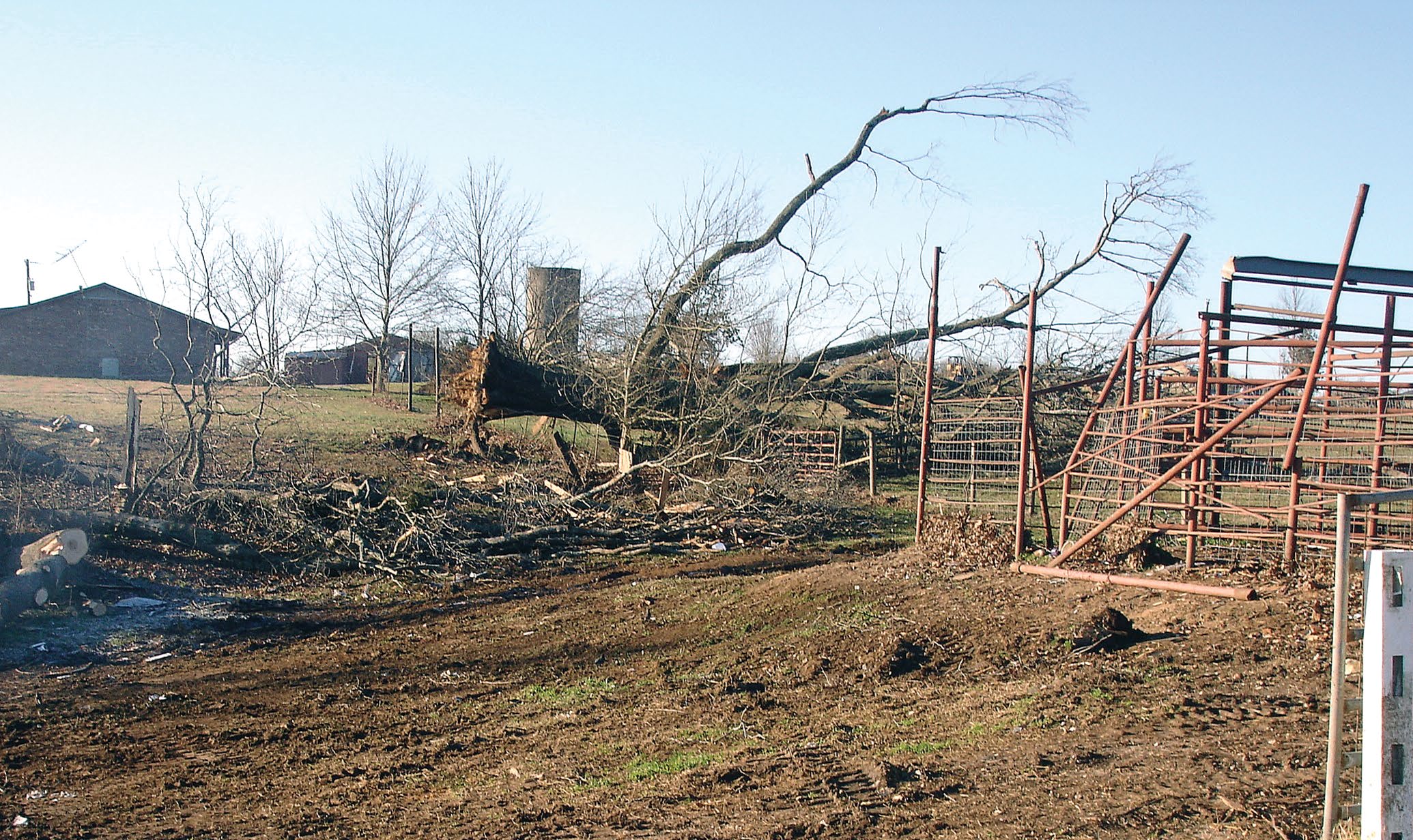 Farmland with debris and property damage caused by a hurricane.