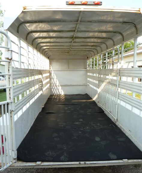 Rubber mats in the floor of a white trailer. 