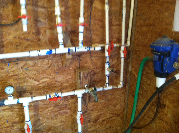 A three-fourths-inch supply line from the well that decreases to half-inch distribution lines to the drinkers inside the control room (may not supply adequate volume).