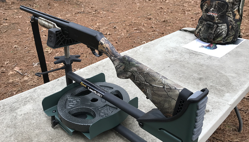 A hunting rifle is set up for target practice.