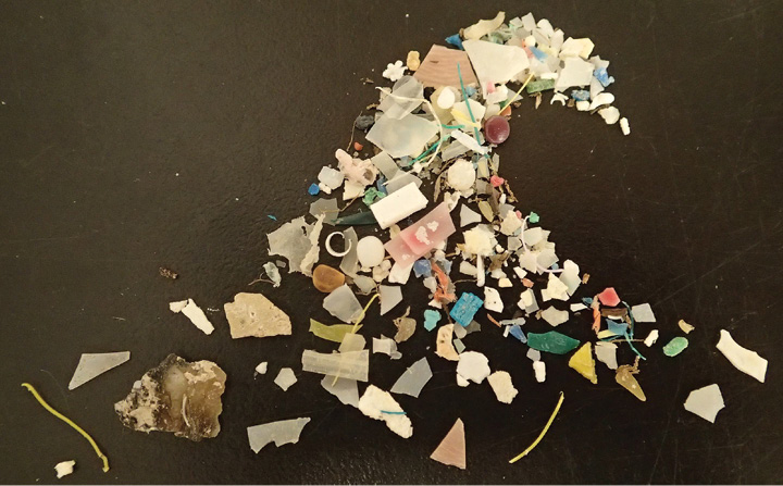 A pile of small pieces of plastic of various colors, shapes, and sizes.