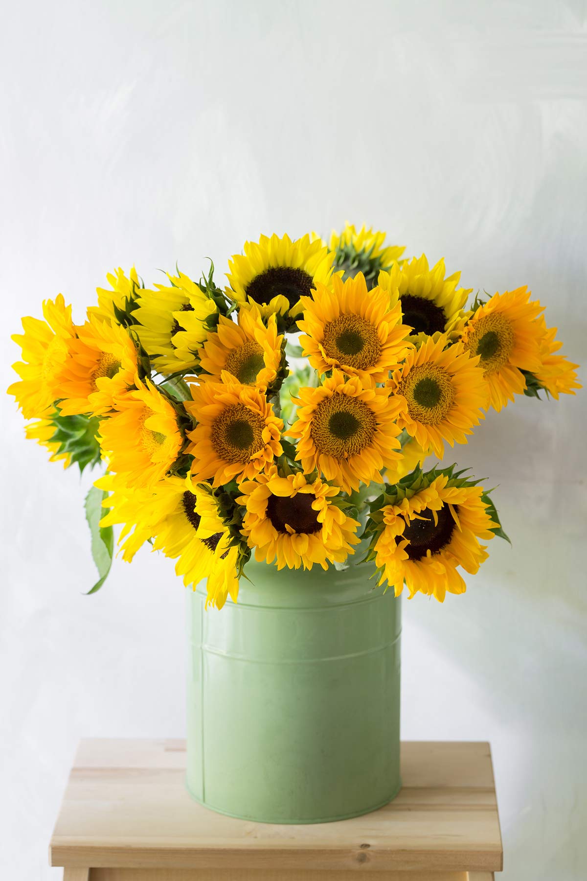 A container filled with yellow sunflowers.