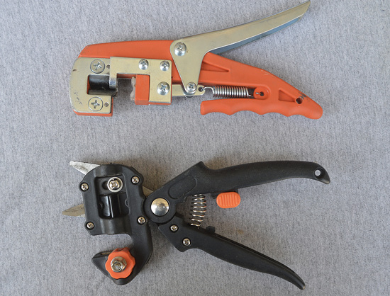 Two handheld grafting tools.