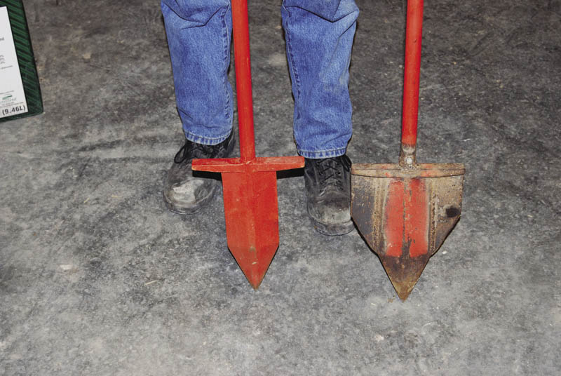 A person displays two digging tools used to plant seedlings. One has a narrow spade, and the other has a wide spade.