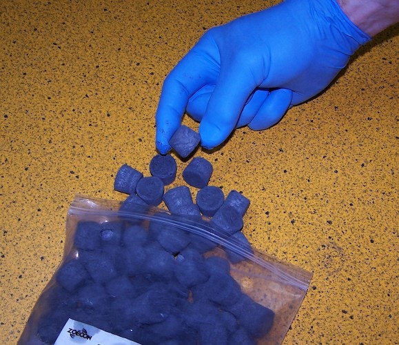 A plastic bag of blue tablets.
