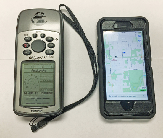 A handheld GPS unit next to an iPhone.