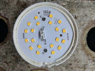 The inside of an LED lamp has 20 small, square electronic chips.
