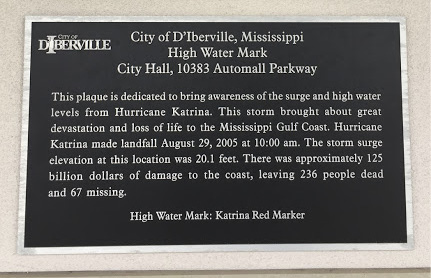 A plaque with information on the impacts of Hurricanes Camille and Katrina to the Mississippi Gulf Coast.