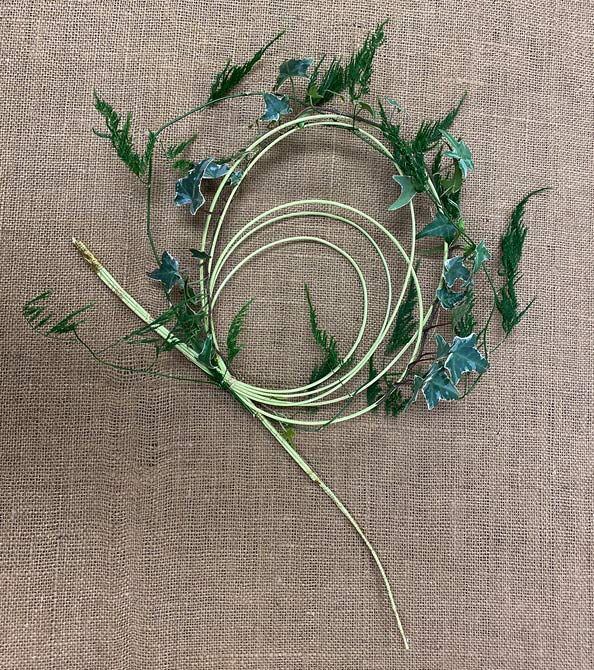 Bullion wire folded into large loop for support of dianthus bouquet. The loop is decorated with a bit of ivy for added flair.
