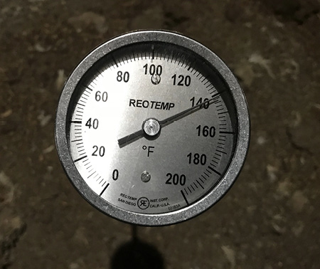 A thermometer measuring 140 degrees F.