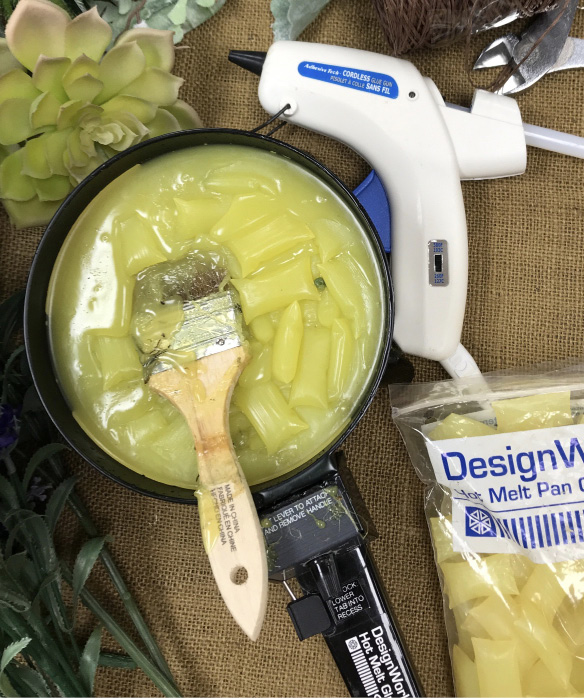 Glue pans or melt pans are electric skillets specifically made to warm hot glue chips, shown right, for the primary adhesive in floral design. A natural hair paint brush is used to apply the glue from the pan. Glue guns are useful for smaller areas of the design.