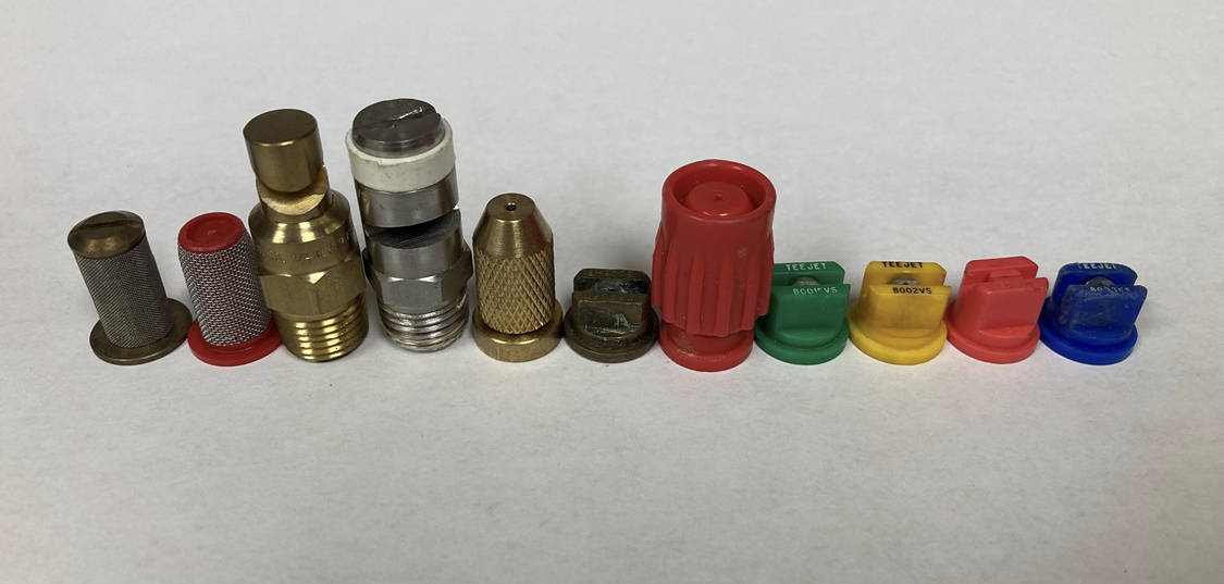 A variety of different spray tips and strainers.