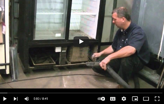 Screen capture from a video of a technician working on a floral cooler.