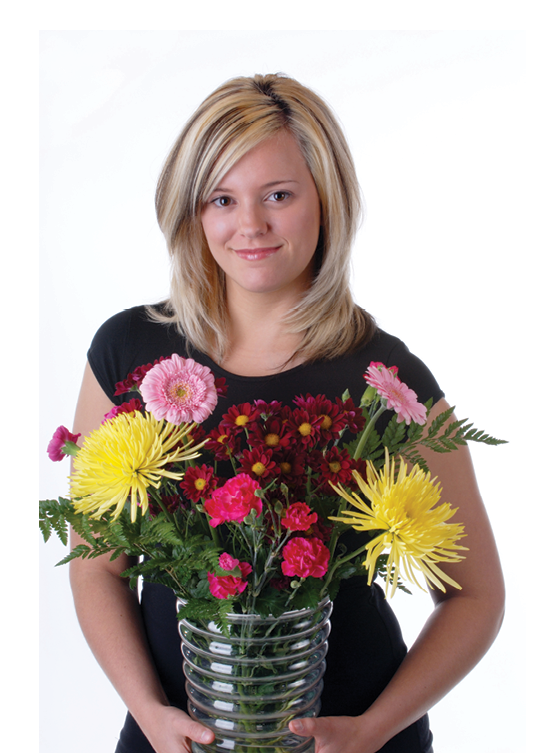 A person holding a vase of flowers.