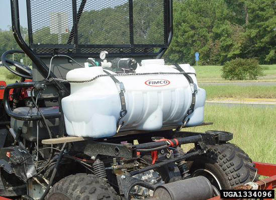A white container strapped to the back of an ATV.