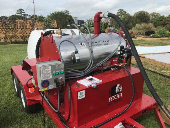 A large piece of equipment with hoses and water tanks.