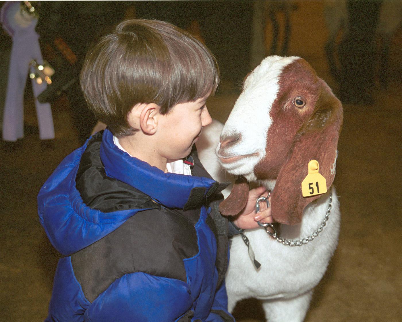Ten-year-old Nolan Webb of Lafayette County 4-H has one last visit with Showboy, the grand champion market goat at the 2002 Dixie National Junior Livestock Show in Jackson, Miss., on Feb. 7, 2002.