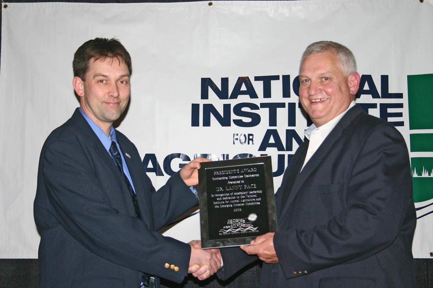 Dr. Lanny Pace (right), executive director of the Mississippi Veterinary Diagnostic and Research Laboratory System, receives the National Institute for Animal Agriculture President's Award for exemplary leadership and dedication to the Institute from Dr. Robert Fourdraine, NIAA vice chair. (Submitted photo)
