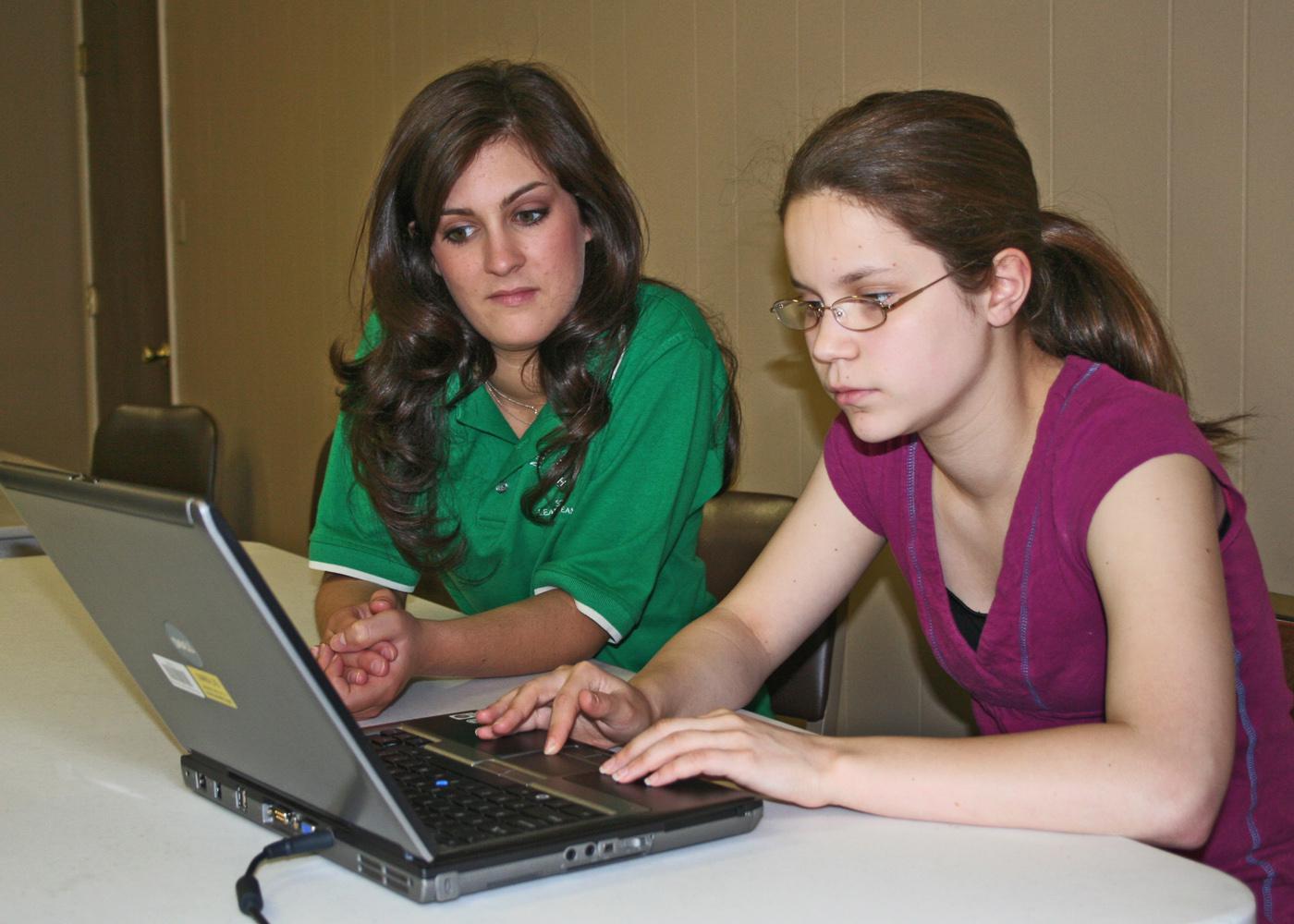 Chelsi Smith, 18, of Guntown, and Ashley Gray, 16, of Tupelo, complete a presentation for the upcoming state 4-H Club Congress at Mississippi State University May 27-29. Smith, a Saltillo High School graduating senior, will complete her year as president of the state 4-H Council during the event. (Photo by Patti Drapala)