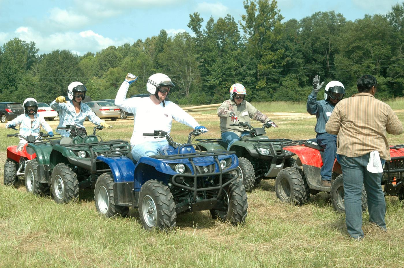 Five members of Mississippi State University's 4-H program staff raise their right hands to signal Clay County youth agent Fran Brock, who serves as the starter. From left are Betty Rawlings, Mary Riley, Landon Summers, Morris Houston and Harvey Gordon, who were test subjects for Brock's certification as a national ATV safety instructor. (Photo by Patti Drapala)