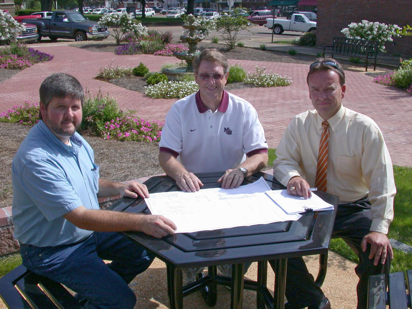 Chickasaw County Extension agent Scott Cagle, left, discusses improvements for Houston Garden Park in the town square with local Master Gardener president John Walden, center, and city mayor Stacey Parker. (Photo by Artis Ford)