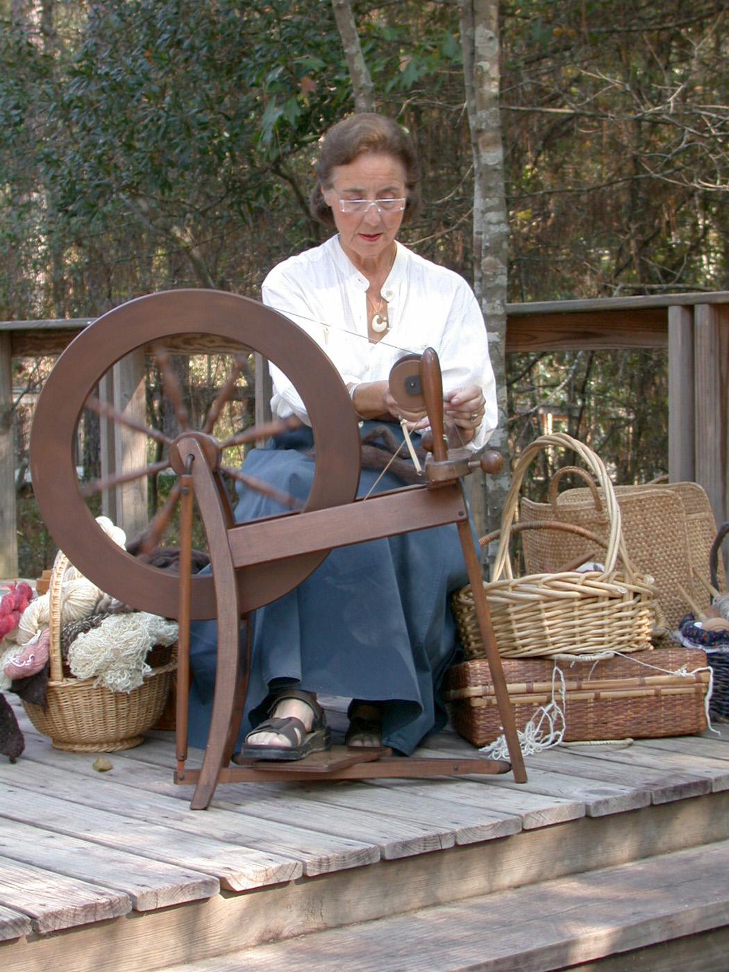 Yvette Rosen demonstrates spinning to guests of a previous Piney Woods Heritage Festival at Crosby Arboretum. The festival provides an opportunity to learn about the arts and heritage crafts of the region. (Photo courtesy of Crosby Arboretum)