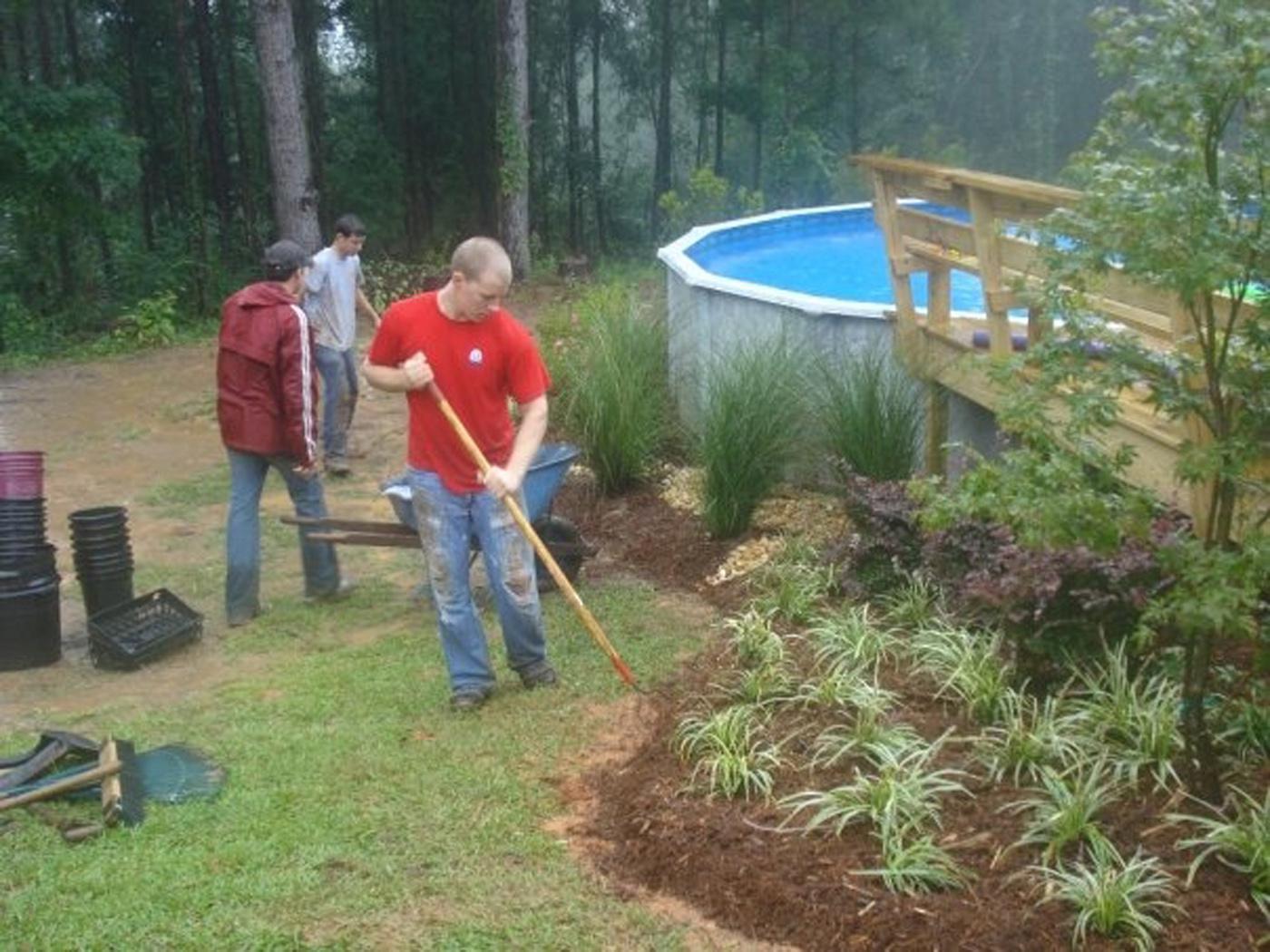 Mississippi State University's Landscape Architecture Delegates volunteered to help the family of a young girl with a serious nerve disorder. David Russell, Dustin Randall and Dale Brasher place plants around the family's pool to keep the soil intact. With the erosion problem solved, the girl can continue her regular pool therapy to ease her chronic pain.