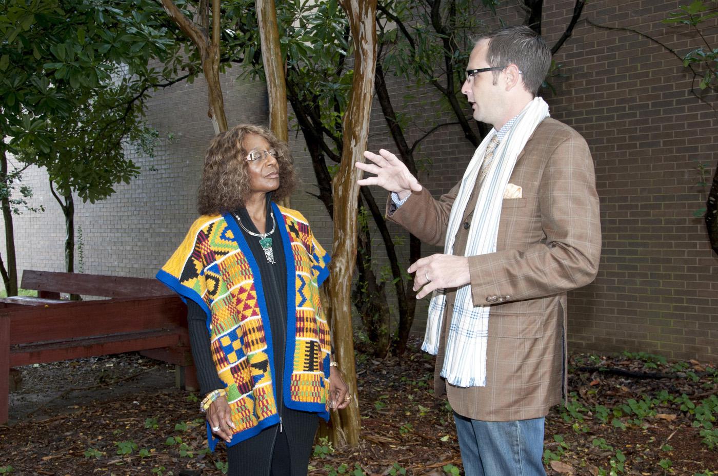 Phyllis Miller shows how to combine clothing from past seasons and travels to create a unique personal style by pairing her award-winning Kente wrap design over a black sweater dress with accessories from around the world. Charles Freeman models a layered look with a custom-made wool jacket paired with jeans bought on clearance at Target.