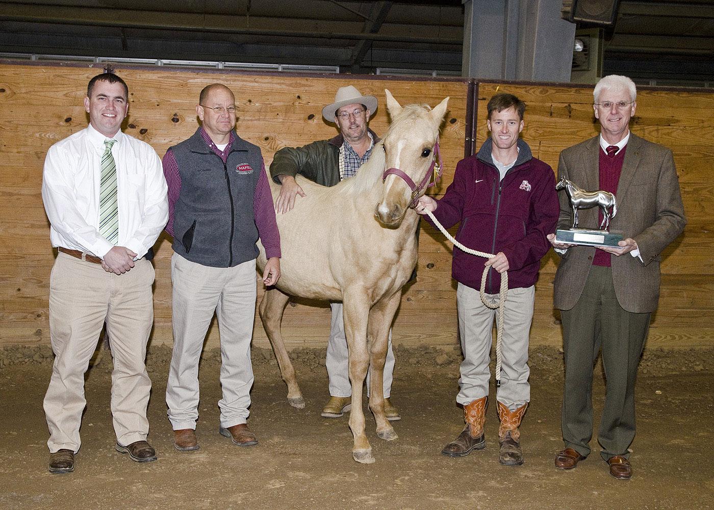 Veterinarians in the Mississippi State University College of Veterinary Medicine's theriogenology (reproduction) group stand with one of the MSU weanlings, the grandson of Dash for Cash, a champion American Quarter Horse. Pictured before the recent MSU horse sale are Drs. Heath King, David Christiansen, Richard Hopper, Kevin Walters and Peter Ryan. The AQHA recently recognized MSU for its efforts to maintain the quality of the breed. (Photo by MSU College of Veterinary Medicine/Tom Thompson)