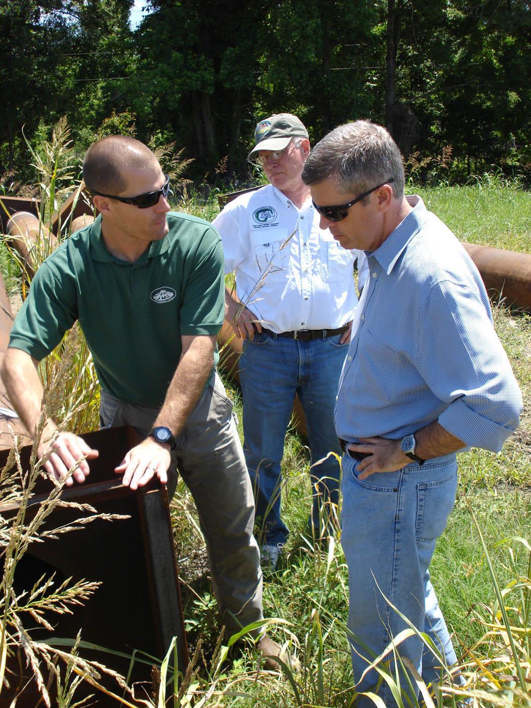 Mississippi State University professor of aquatic sciences Robbie Kroger (left) demonstrates how a riser pipe works to trap sediment and increase water quality to Ben Scaggs (right), director of the Environmental Protection Agency's Gulf of Mexico Program and Phil Bass (center), executive director of the Gulf of Mexico Alliance. The site visit was part of a new conservation initiative called Research and Education to Advance Conservation and Habitat. (Submitted Photo)