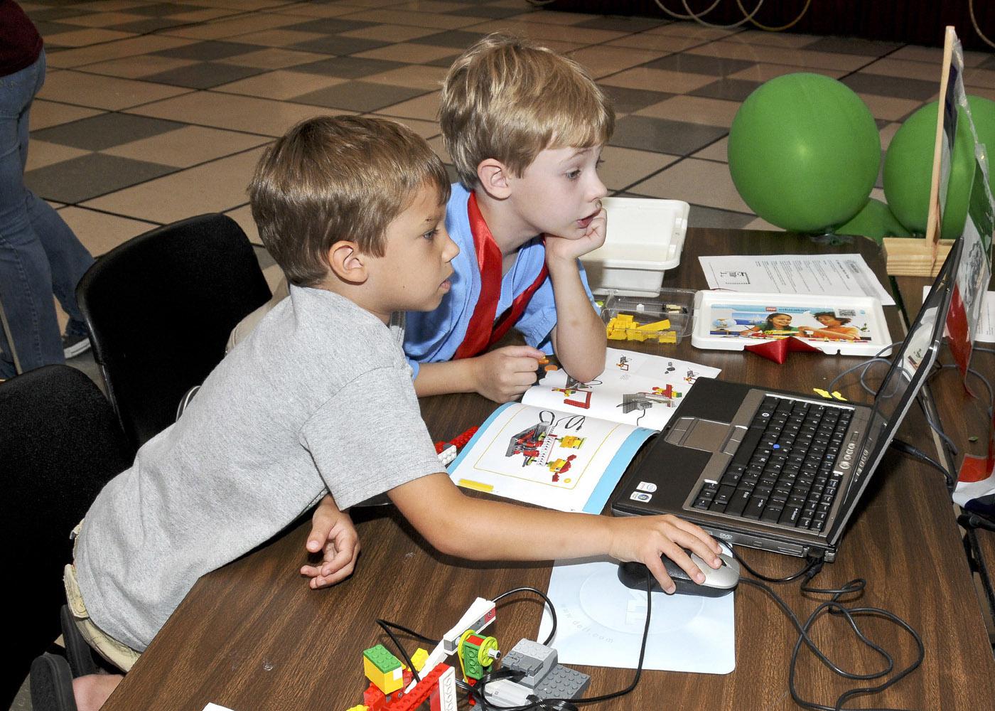 Ethan Hicks and Eric Mellin of Starkville follow instructions to program the soccer goalie robot they built at the Cloverbud Camp held at Mississippi State University. (Photo by MSU Ag Communications/Scott Corey)