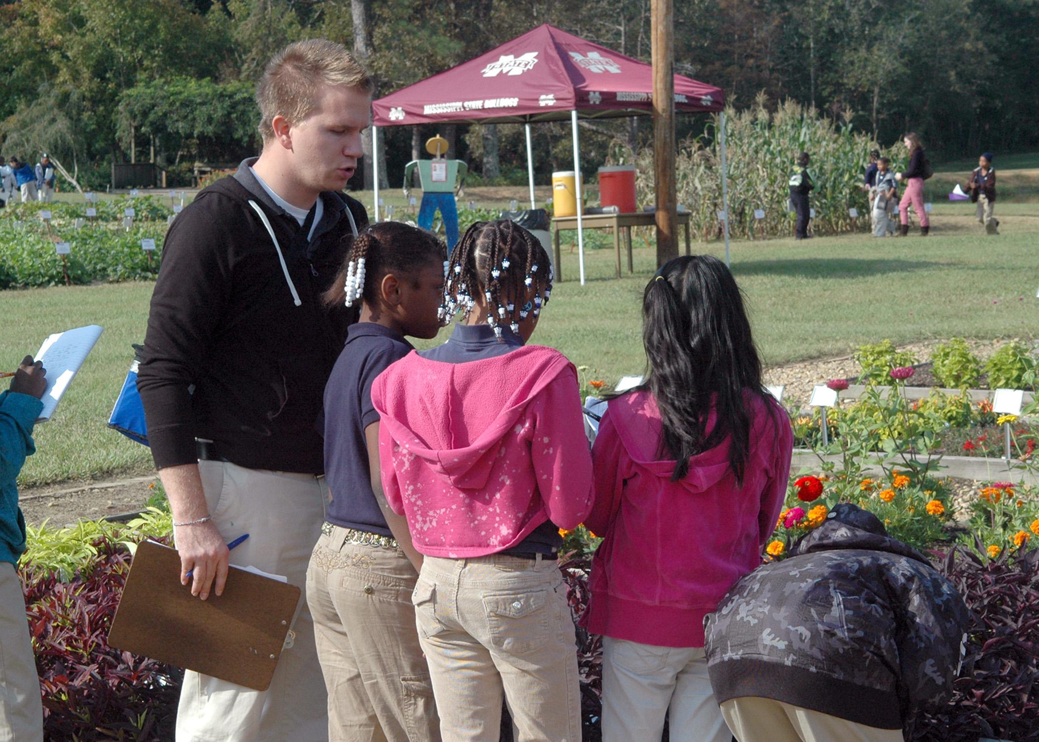 Emory Williamson, a fourth-grade teacher at Hazlehurst Elementary School, instructs his students to write down names of plants they saw during the Youth Fall Gardening Fest Oct. 9 and 10 at the Truck Crops Branch Experiment Station in Crystal Springs. (MSU Ag Communications/Susan Collins-Smith)