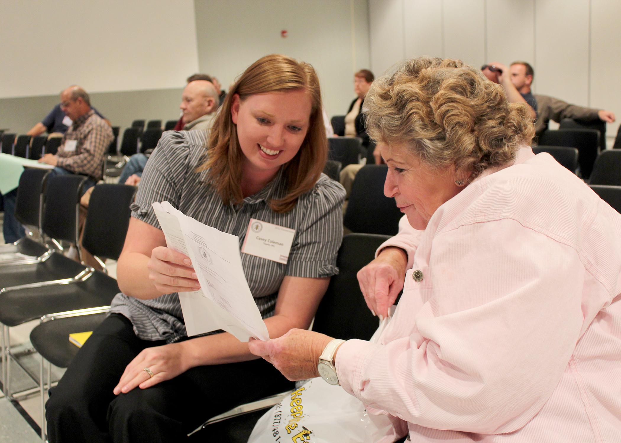 Casey Coleman of Tupelo and Patricia Pendergrass of Louisville review the agenda while waiting for the beginner beekeeper workshop to begin Friday, Oct. 26, 2012, at the annual Mississippi Beekeepers Association conference, held at Mississippi State University. (Photo by MSU Ag Communications/Keri Collins Lewis)