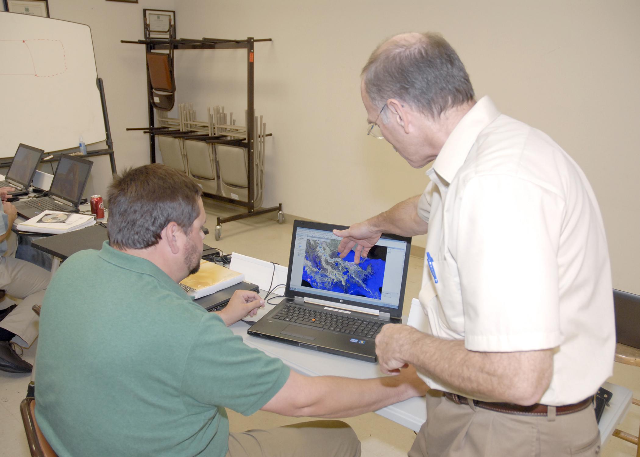 Jim Davis of Olive Branch, left, with the Mississippi Department of Transportation, learns how to use new software from Scott Samson, professor with the Extension Service and the Geosystems Research Institute at Mississippi State University, during a class in Hernando on Oct. 17, 2012. (Photo by MSU Ag Communications/Linda Breazeale)
