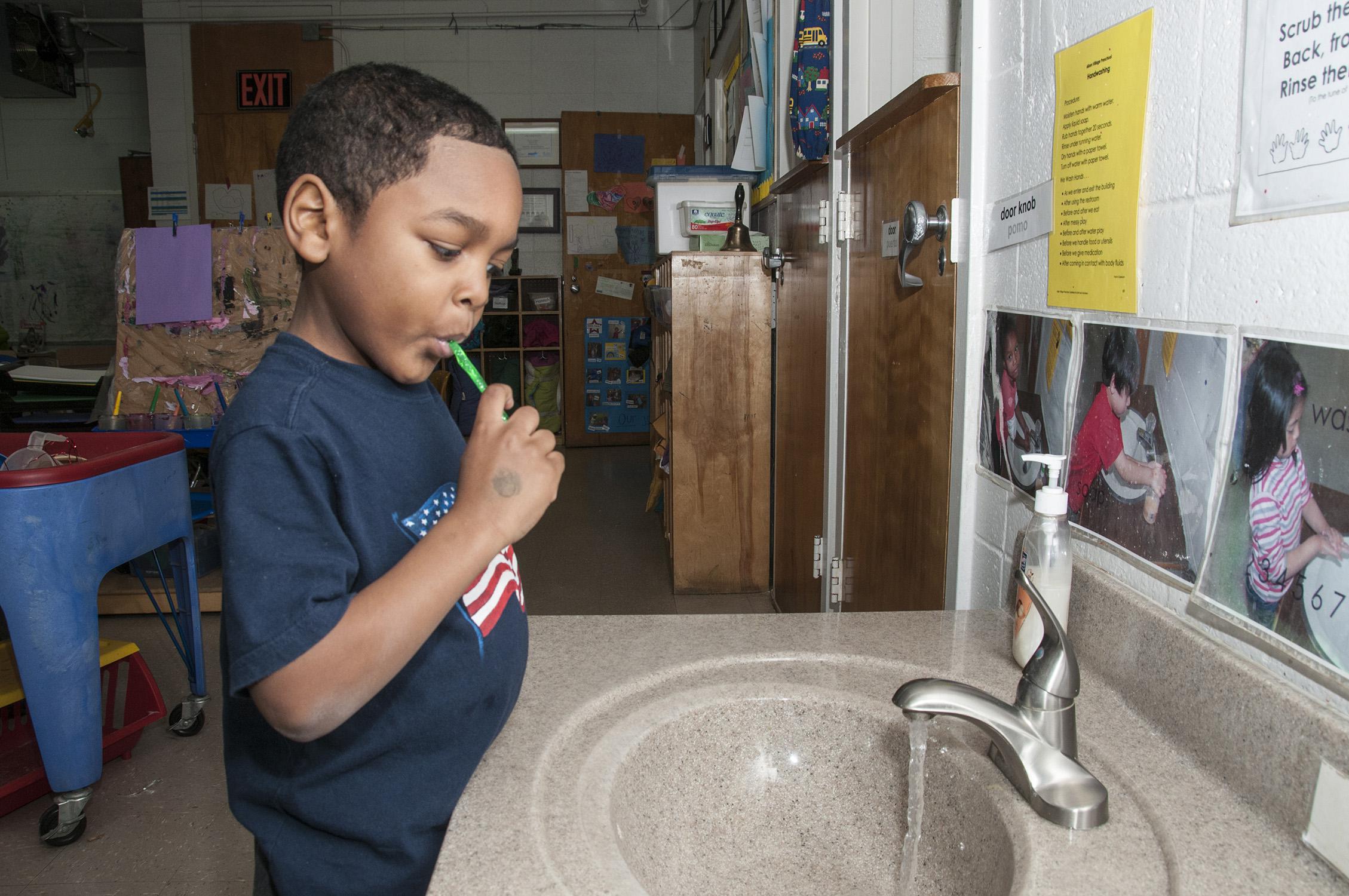 Mississippi State University Aiken Village Preschool student Deshaun Phillips brushes his teeth to prevent cavities and maintain good dental hygiene on Feb. 18, 2013. (Photo by MSU Ag Communications/Scott Corey)
