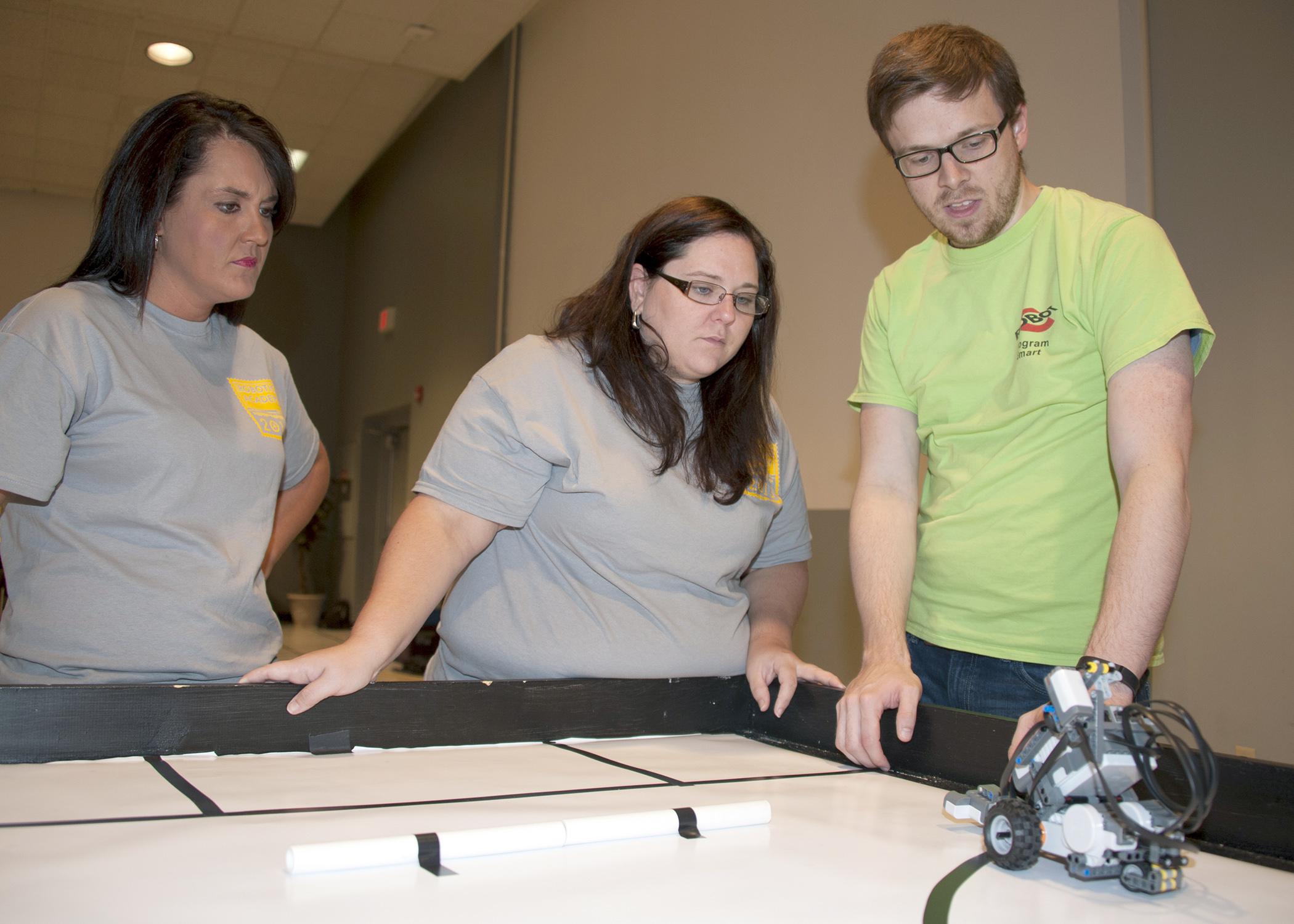Betsy Padgett, Holmes County Extension agent, and Christina Meriwether, Leflore County Extension agent, learn how to program robots at Mississippi State University's 4-H Robotics Academy on Aug. 13, 2013. (Photo by MSU Ag Communications/Kat Lawrence)
