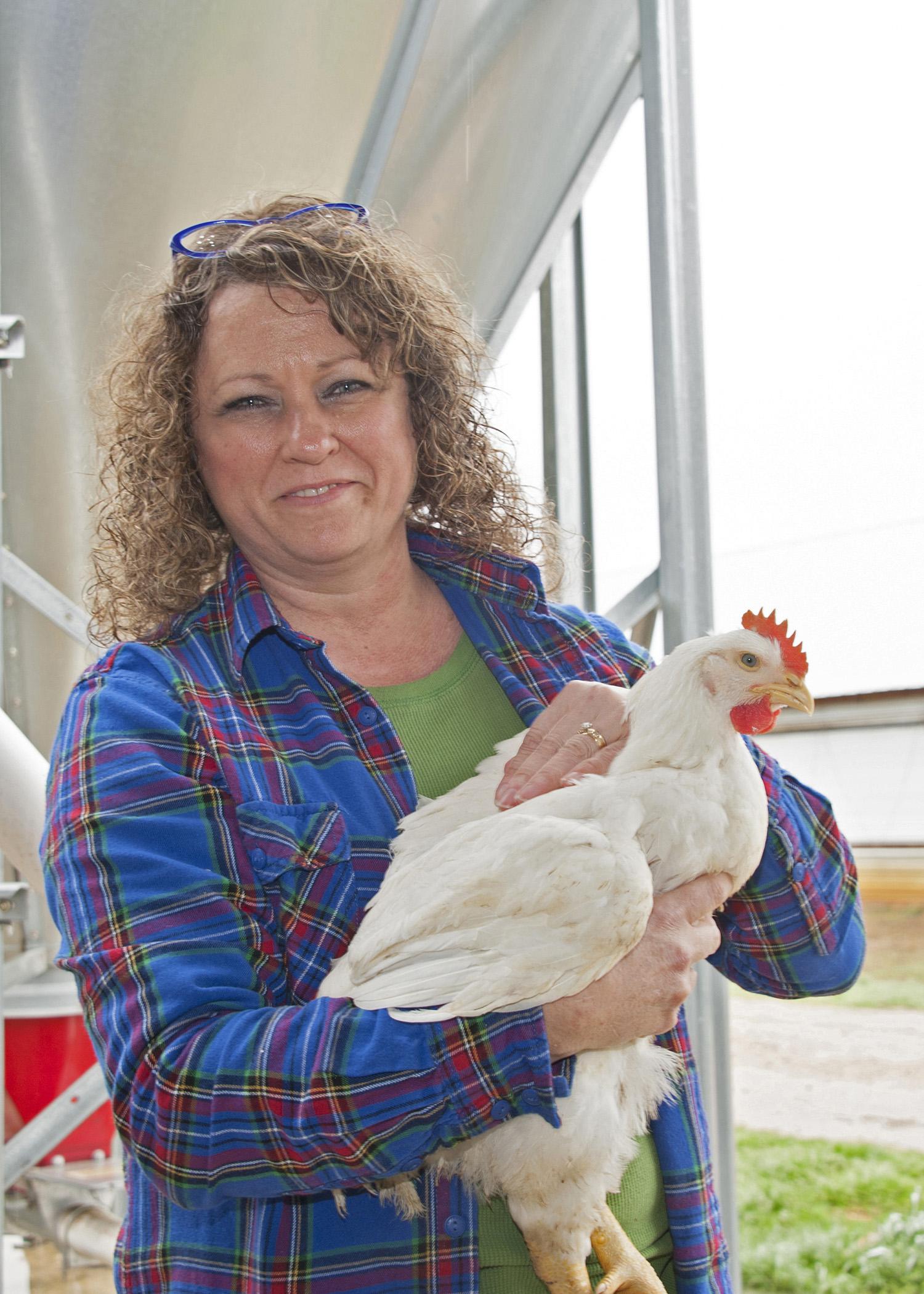 Delean Robertson holds one of her chickens at her poultry farm, Straight Arrow Farm in McComb. Robertson is a member of Mississippi Women for Agriculture and strives to educate others about women's important role in the agriculture industry. (Photo by MSU Ag Communications/Kat Lawrence)