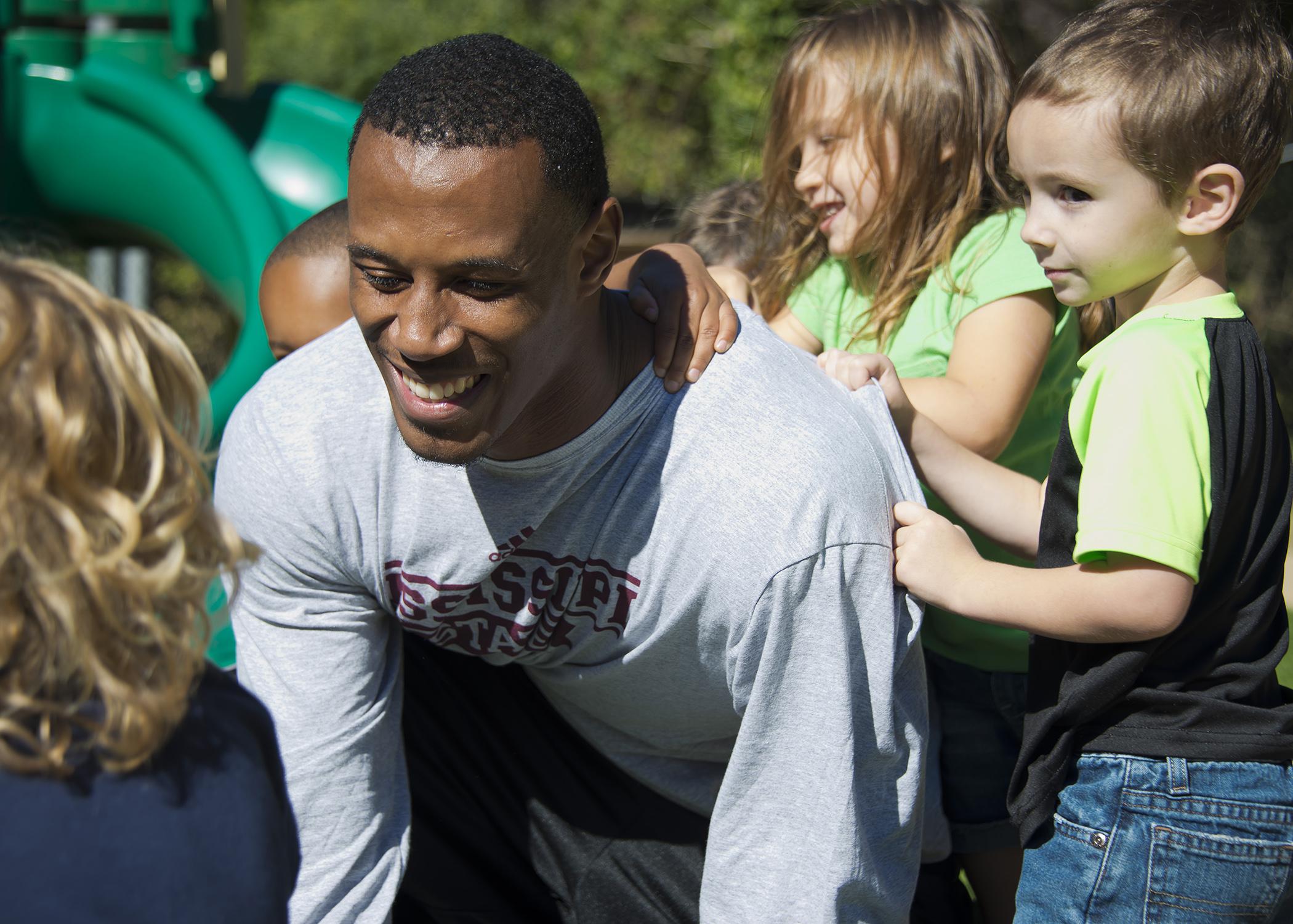 Matt Wells, a senior football player at Mississippi State University, interacts with preschool children during his internship at the MSU Child Development and Family Studies Center. (Photo by MSU College of Agriculture and Life Sciences/David Ammon)