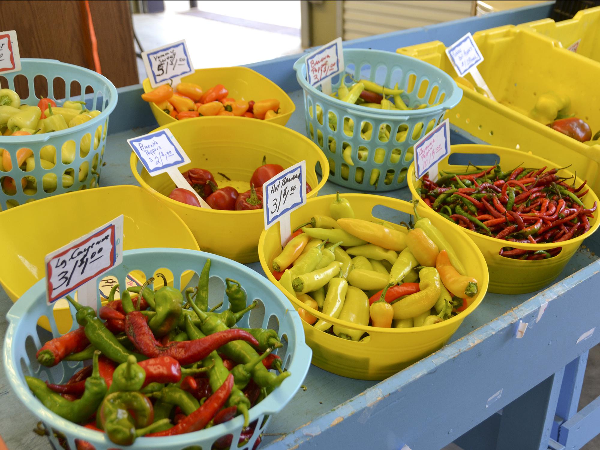 Cooper Farms, located in Smith County, offered a variety of colorful peppers at the Mississippi Farmers Market on High Street in Jackson, Mississippi, Aug. 5, 2014. Consumers increasingly turn to truck crops farmers for locally grown fruits and vegetables. (Photo by MSU Ag Communications/Susan Collins-Smith)