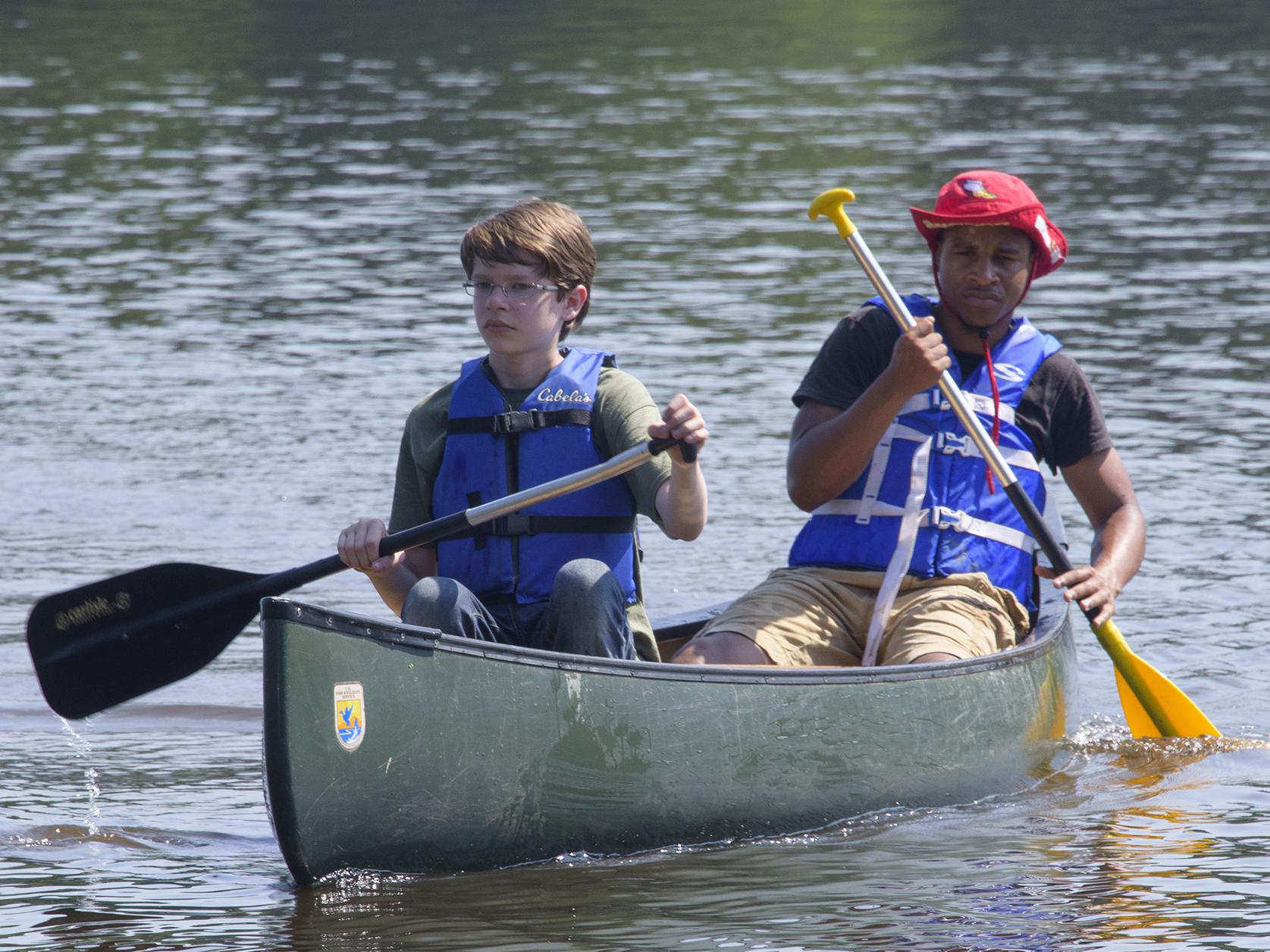 Young campers paddle across a lake during a Mississippi State University conservation camp in 2015. (Photo by MSU Extension Service/Kevin Hudson)