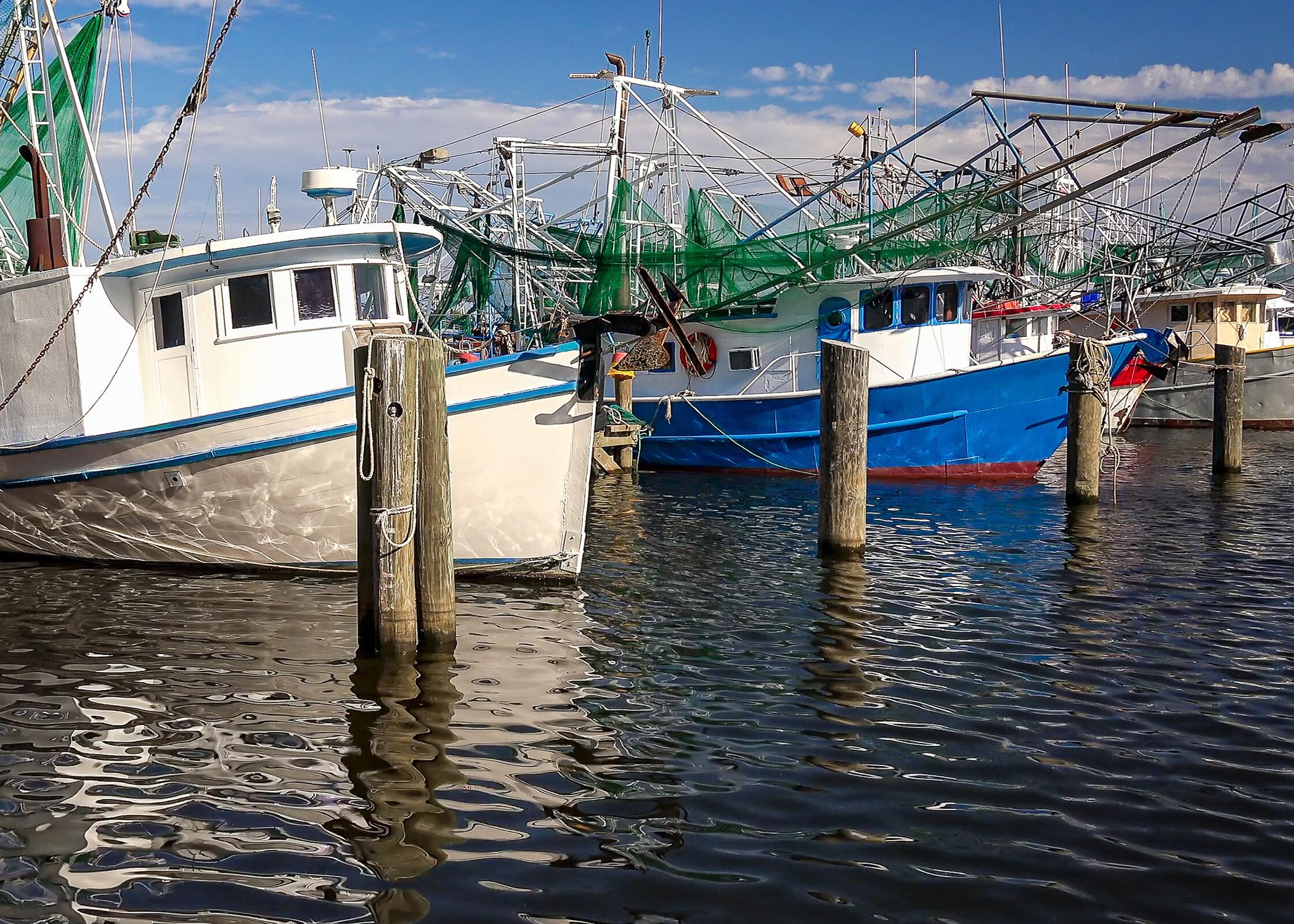 A wooden commercial fishing boat sitting at the dock awaiting season open  in spring.