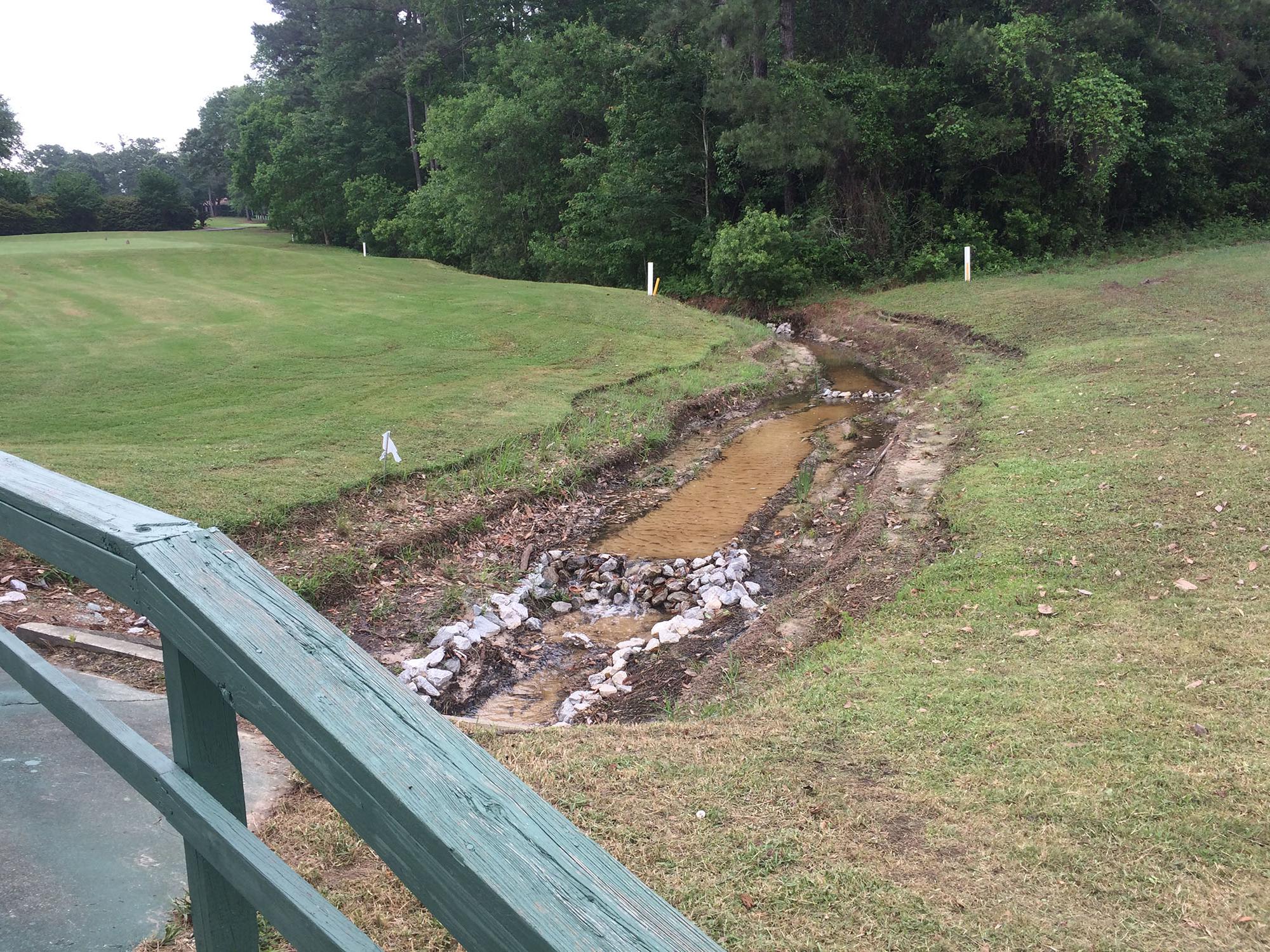 A Mississippi State University associate professor of landscape architecture, working with the Mississippi Water Resources Research Institute, designed this dry swale to reduce nonpoint-source pollution from runoff at a south Mississippi golf course. (Photo by MSU Extension Service/Beth Baker).