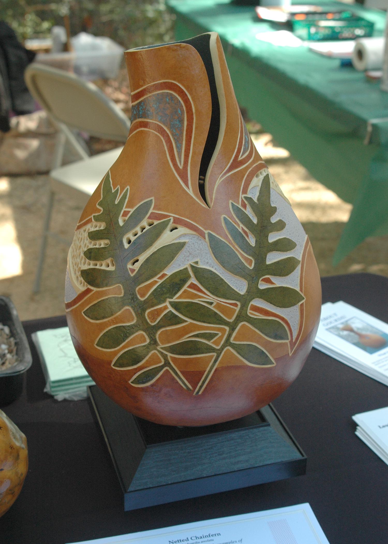 Janet Schlauderaff displayed one of her decorative gourds during the 2012 Piney Woods Heritage Festival at the Crosby Arboretum in Picayune. Schlauderaff’s decorative and functional gourds will be on exhibit in the arboretum’s new art gallery from Sept. 1 to Nov. 30. (Photo by MSU Ag Communications/Susan Collins-Smith)